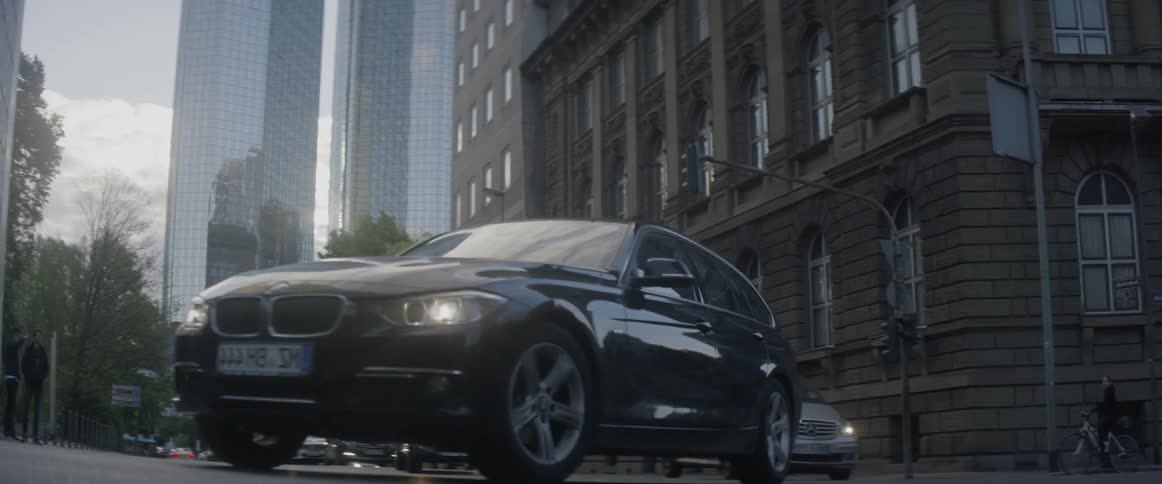 Cars drive on a city street