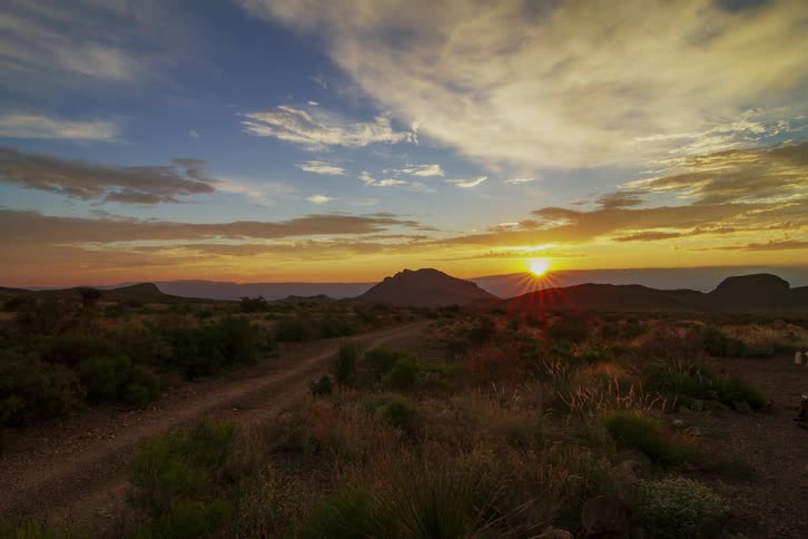 The sun rises over mountains