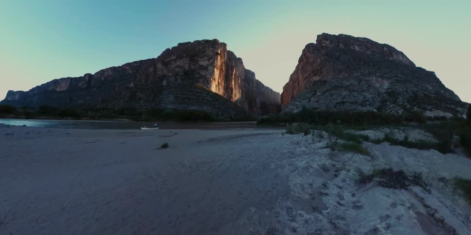 Two large cliffs are on either side of a path leading through them