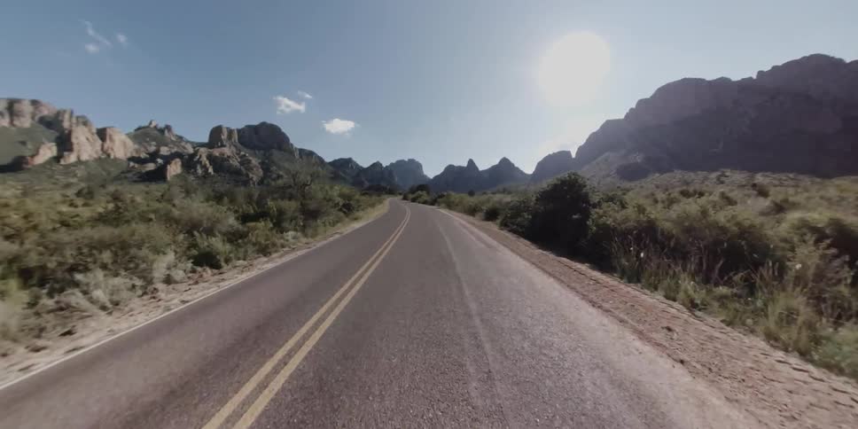 Time lapse of a car driving down a road with twists and turns