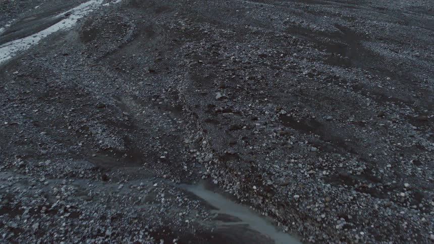 Dirt and rocks cover a rural field