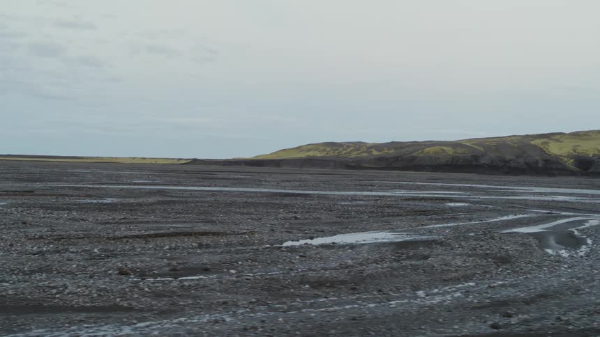 Dirt and puddles cover a rural field
