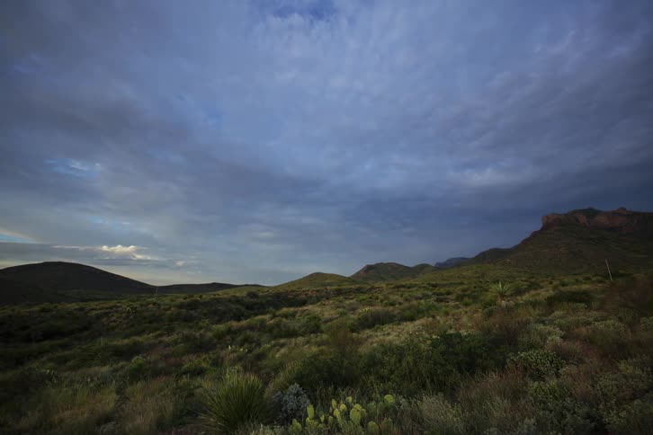 Clouds float over a rural landscape at sunrise