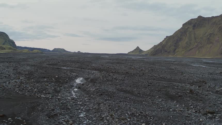 Water flows in thin ribbons through the rocky land