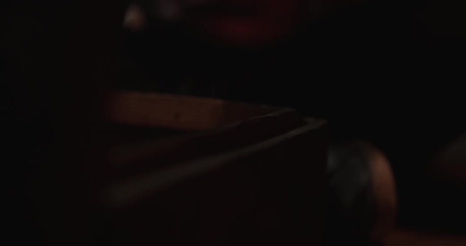 Person taking lid off of wooden box