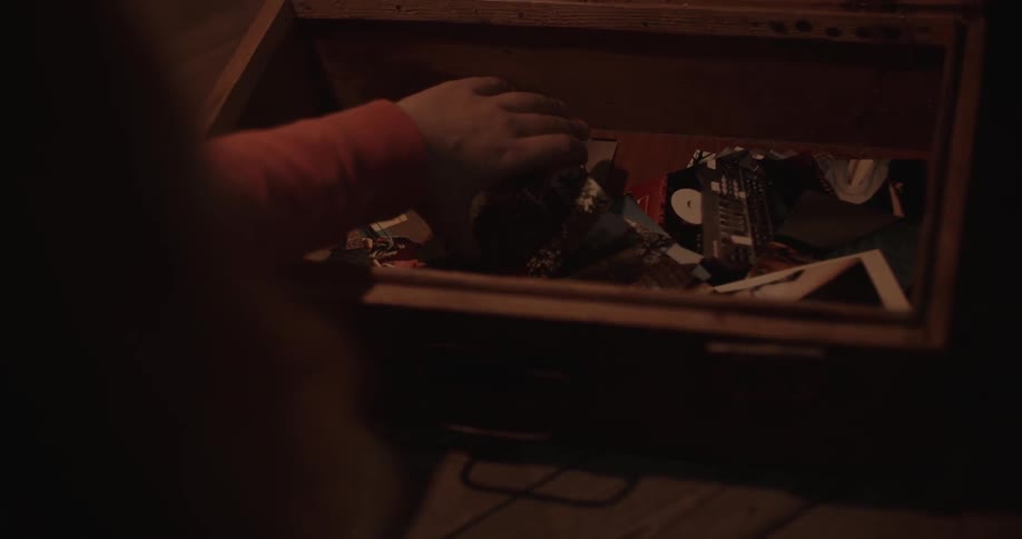 A girl removes a photograph from a box