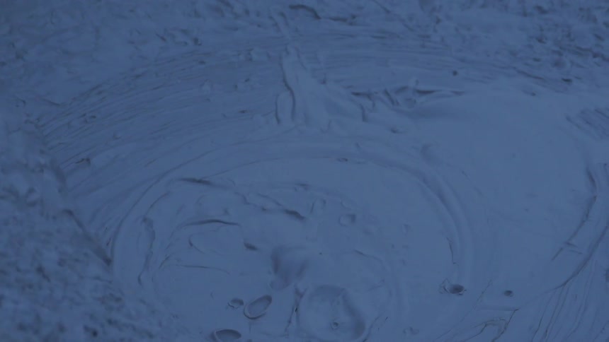 Some grey liquid bubbles and steam comes off