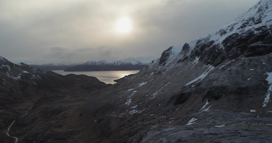 The mountains are covered with snow at sunset