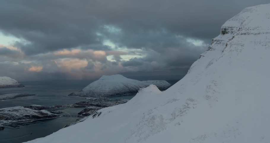 Snow covered mountain at the edge of the ocean