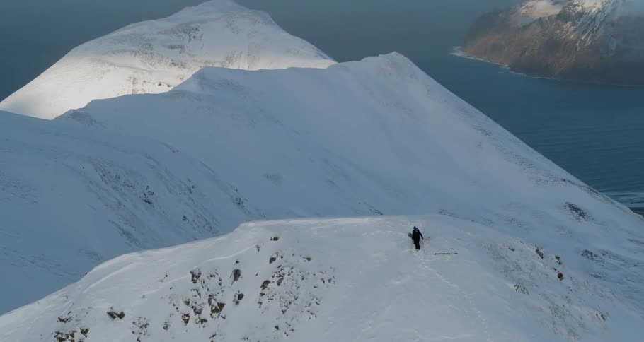 Skiers are hiking up a snow-covered mountain