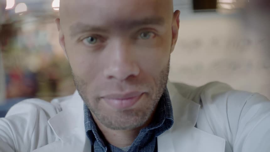 An optometrist puts glasses on a patient