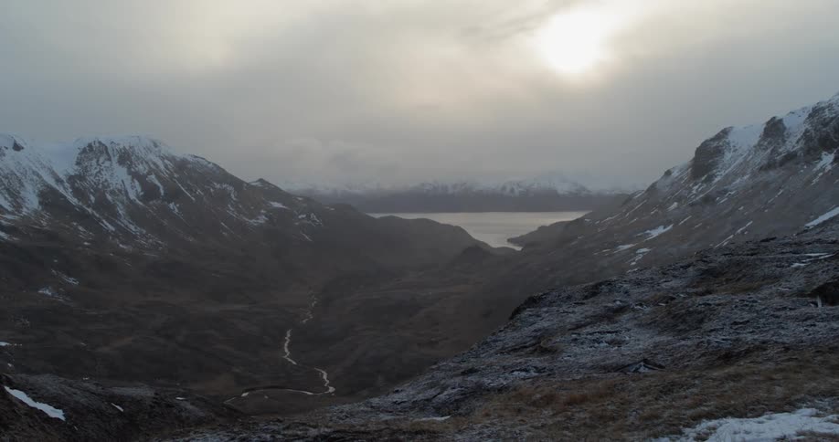 Hills and valleys sit under an overcast sky