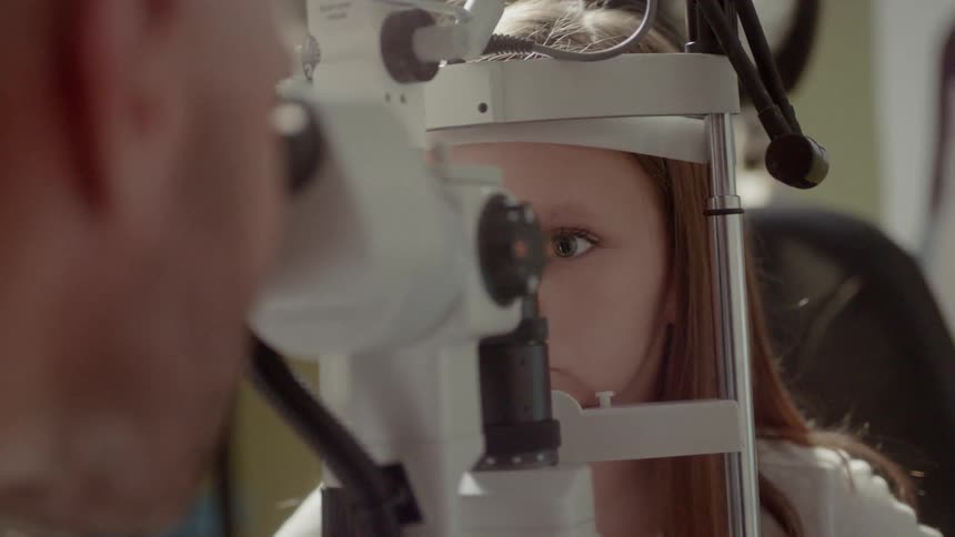 An optometrist examines a patient's eyes