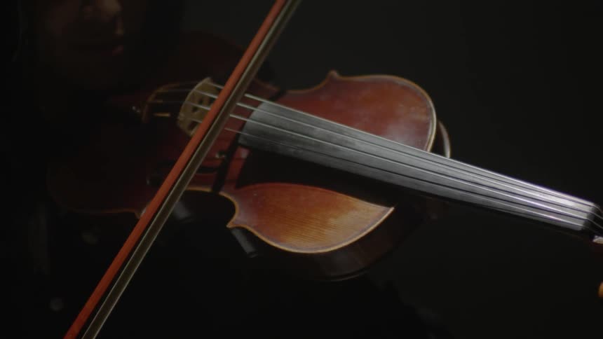 A woman plays a violin