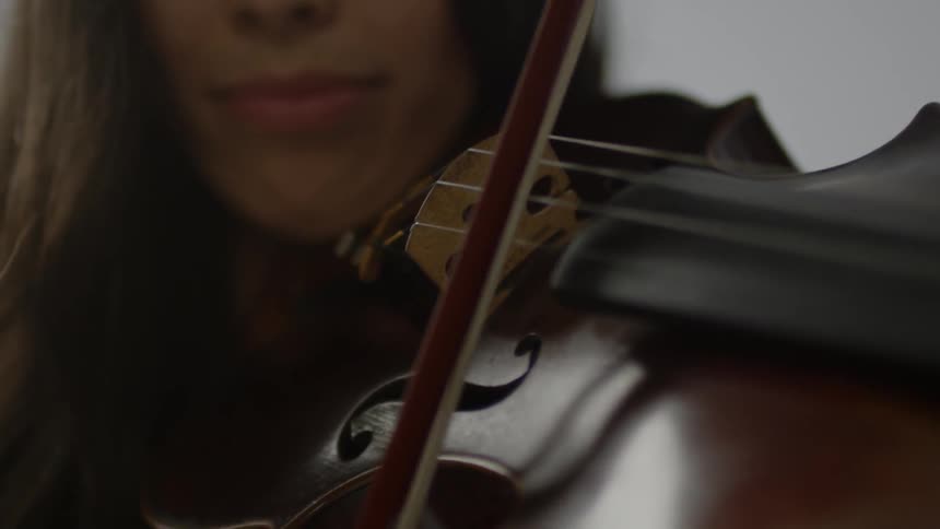 A woman plays a violin