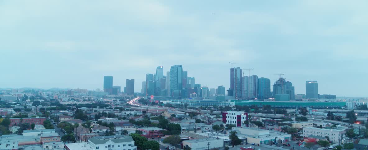 Beyond the homes is a city with tall buildings