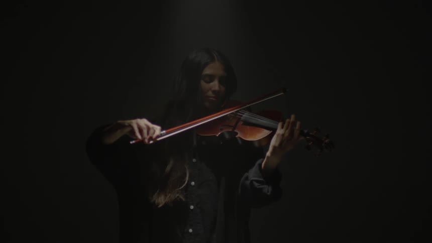 A woman is playing a violin