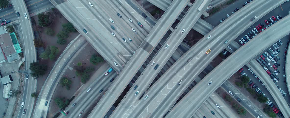 Many roads cross over one another with vehicles driving on them