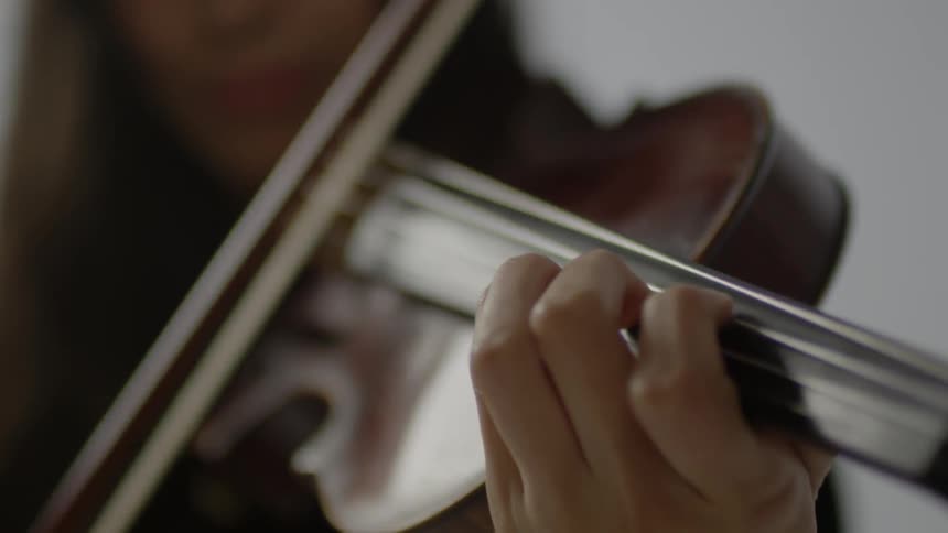 A woman is playing the violin
