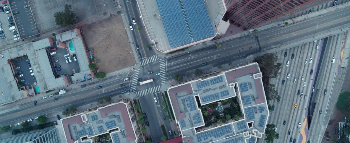 Cars drive on a city street