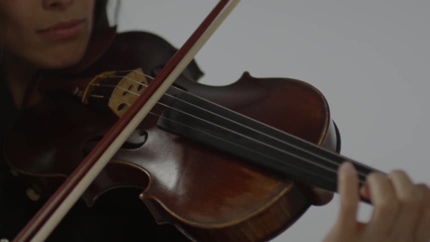 Woman playing a violin indoors