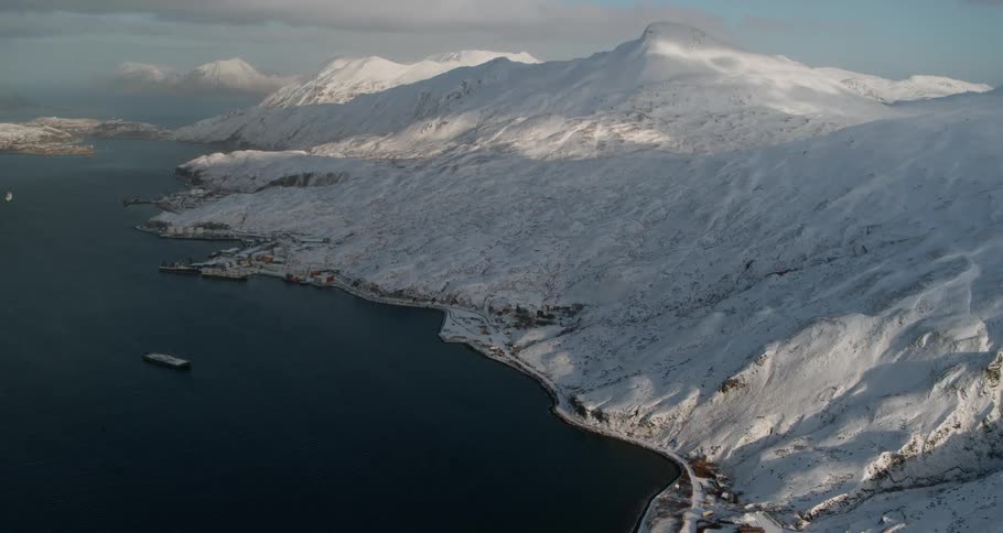 Snowy mountains around the sea