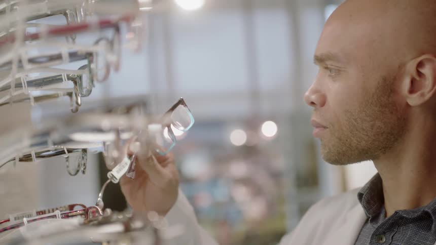 An optometrist inspects a pair of glasses