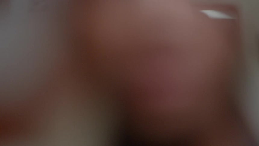 An optometrist puts glasses on a patient
