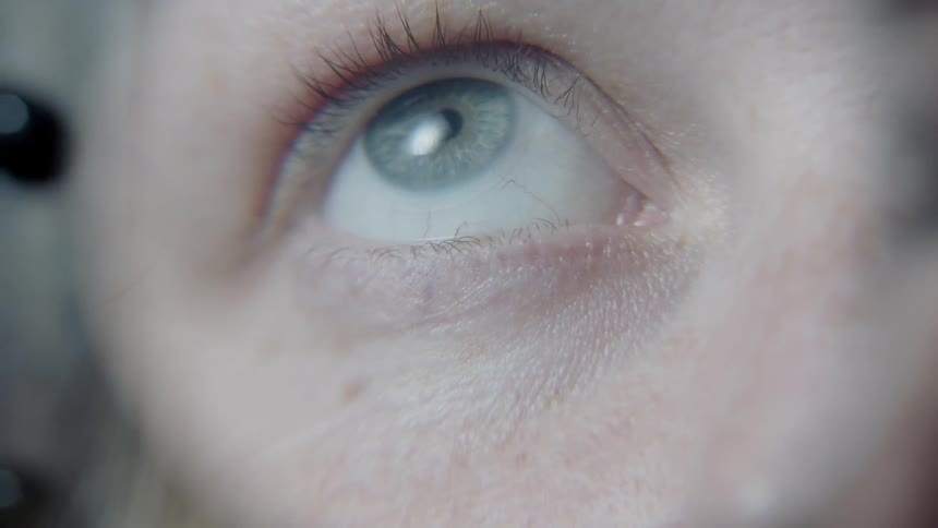 An optometrist examines a girl's eyes