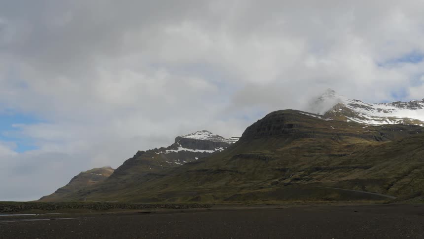 Timelapse of snow capped mountains on a cloudy day