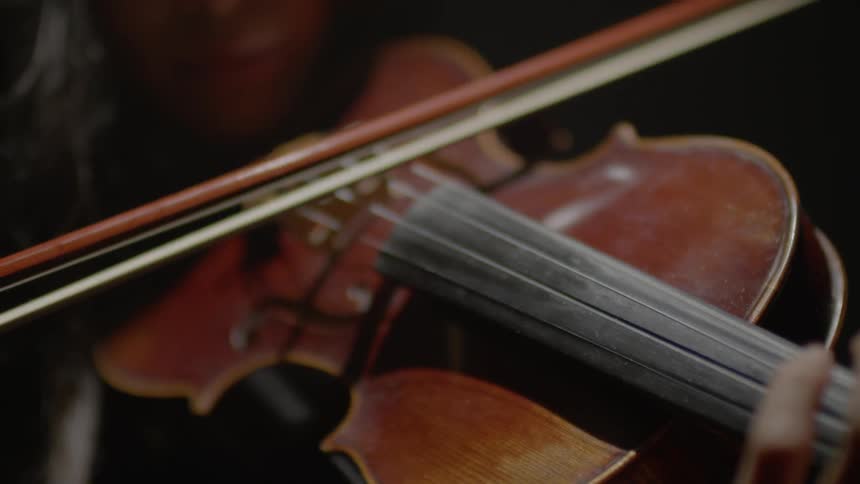 A woman plays a violin