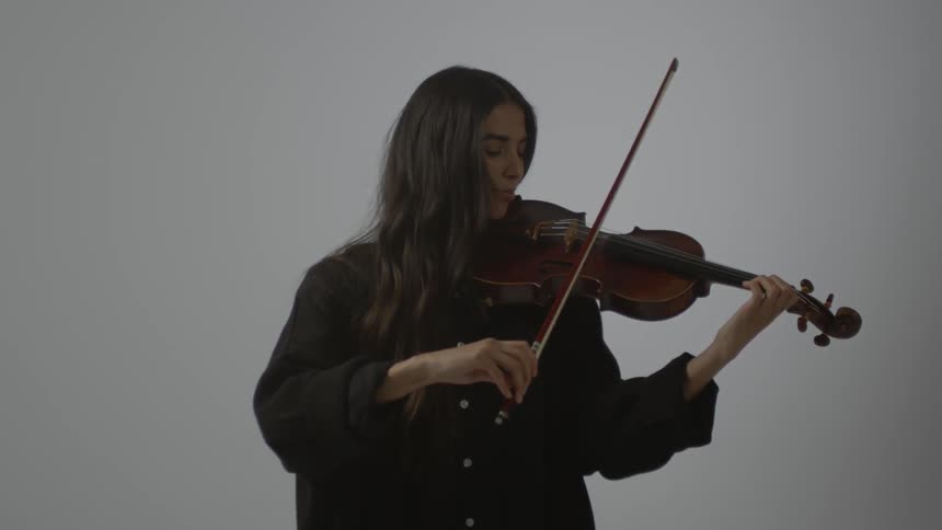 A woman is playing the violin