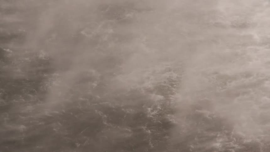 Mist blows over the water