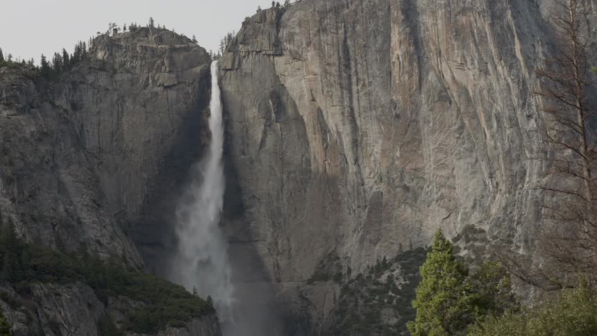 A waterfall is falling over a mountain