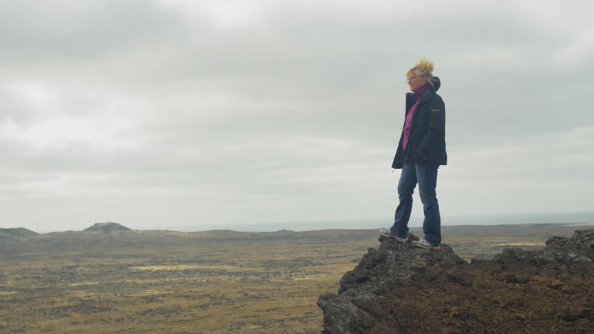 A person standing on a rock