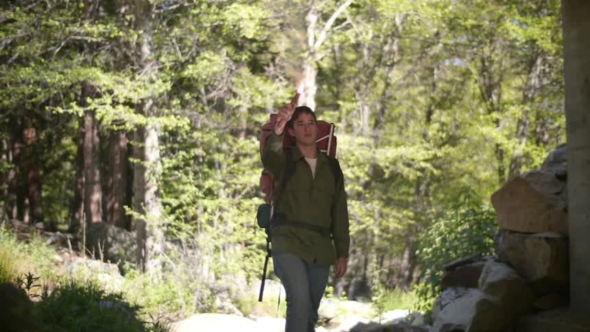 Man hiking lights off a flare