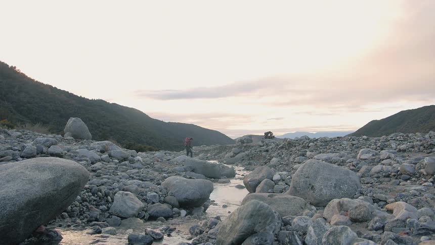 A person walking over rocks