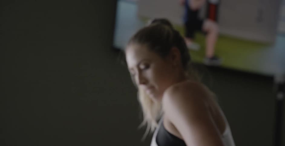 A woman is using resistance ropes in the gym