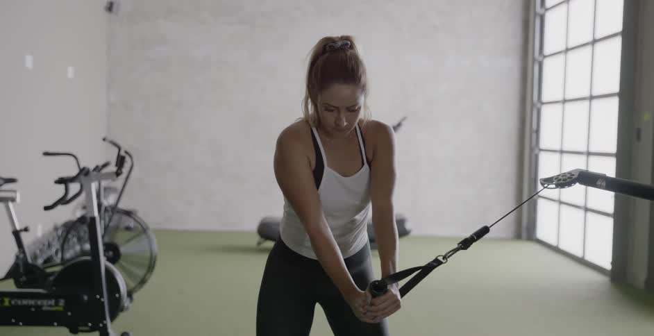 A woman exercises in a gym