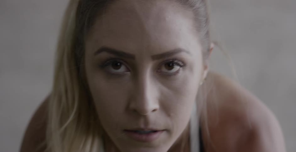 A woman concentrates while exercising