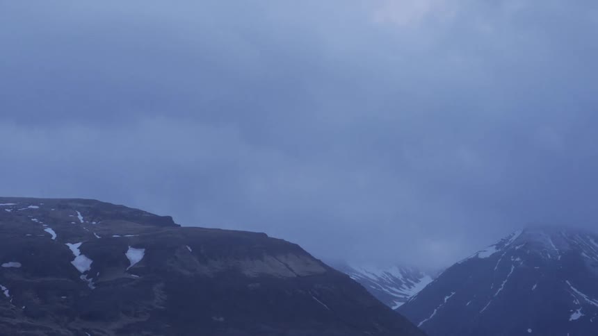 Time lapse of clouds passing over a mountain