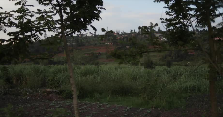 Traveling past fields and people walking on the side of the road