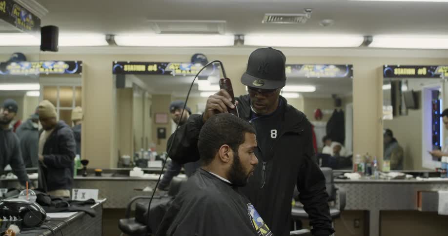 A barber trims a man's hair