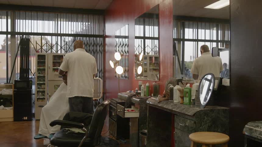 A person is receiving a haircut in a barbershop