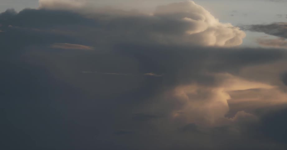 Clouds are billowing around in the sky