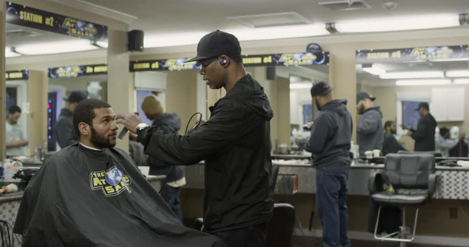 A man gets a haircut at a barbershop
