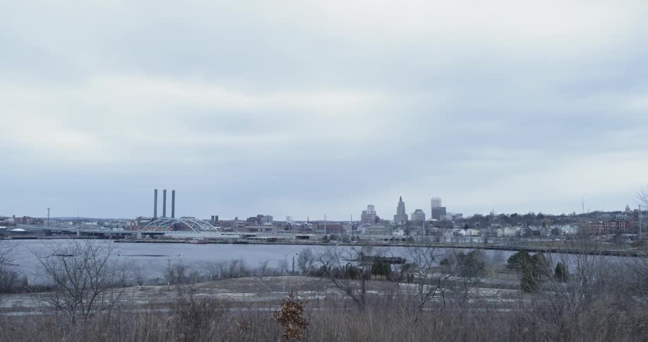 The city skyline is viewed from a distance on a cold day