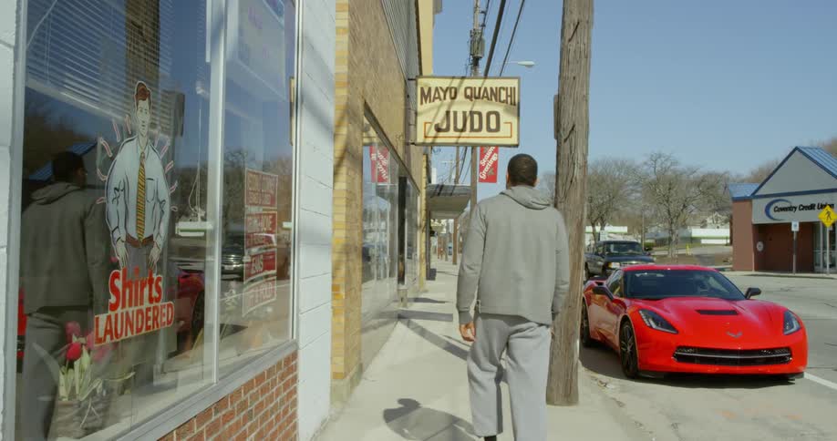 Man walks down sidewalk in a small town