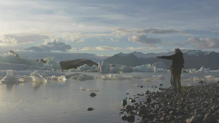Two people staring and pointing at icebergs