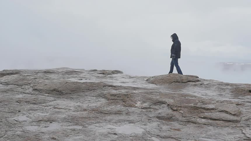 A person walking on a rock